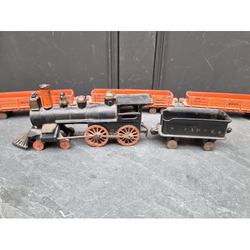 1317 - An antique cast iron 4-4-0 locomotive and four tenders.  ... 