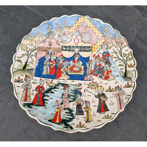 1348 - A Turkish pottery charger, painted with an emperor and attendants, inscribed to base, 38cm diameter.... 