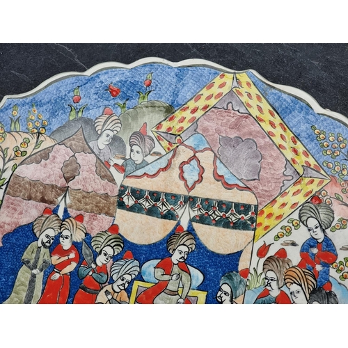 1348 - A Turkish pottery charger, painted with an emperor and attendants, inscribed to base, 38cm diameter.... 