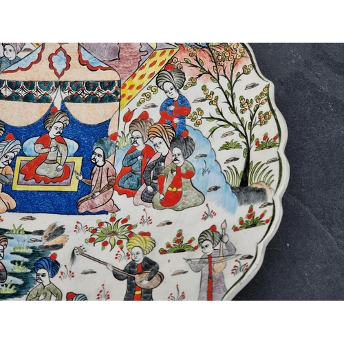 1348 - A Turkish pottery charger, painted with an emperor and attendants, inscribed to base, 38cm diameter.... 