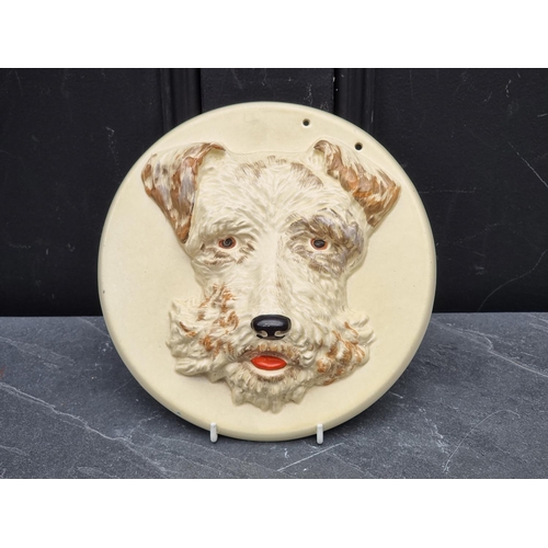 1367 - A Clarice Cliff 'Highland Terrier' wall plaque, 22.5cm wide.