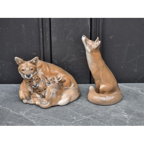 1369 - A Royal Copenhagen figure groups of foxes, 14cm wide; together with another similar fox, 14.5cm high... 