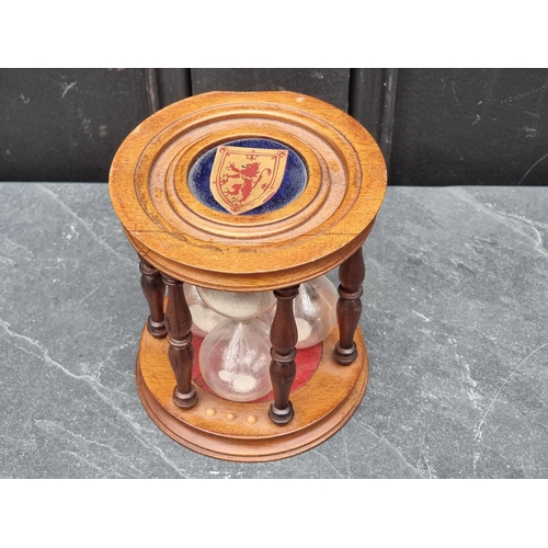 1387 - An unusual mahogany triple egg timer, 14cm high. 