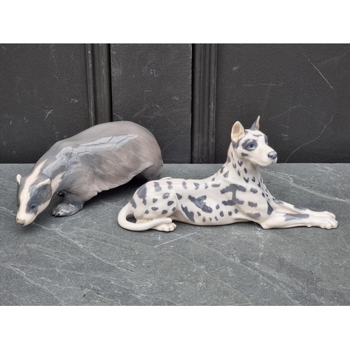 1404 - A Royal Copenhagen Great Dane, 22.5cm long; together with a similar Badger, 19cm long. (2)... 