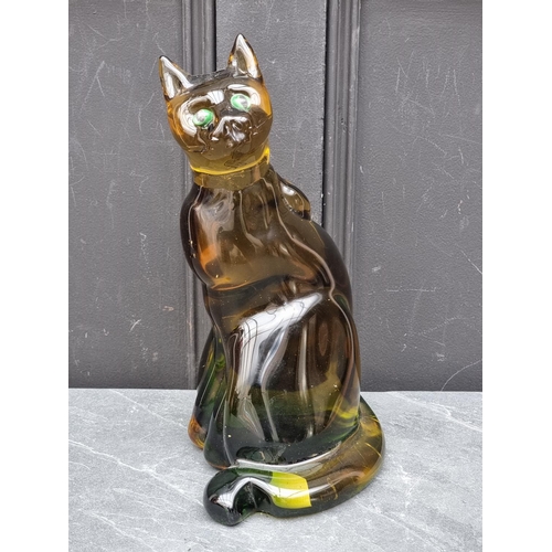 1432 - A large green glass seated cat, 34.5cm high.