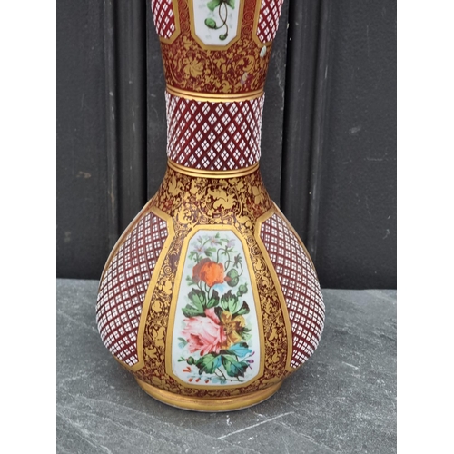 1433 - A large late 19th century Bohemian white overlaid cranberry glass vase, with finely cut and pai... 