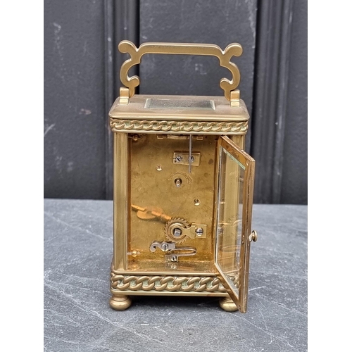 1448 - An old brass carriage timepiece, height including handle 15cm. 