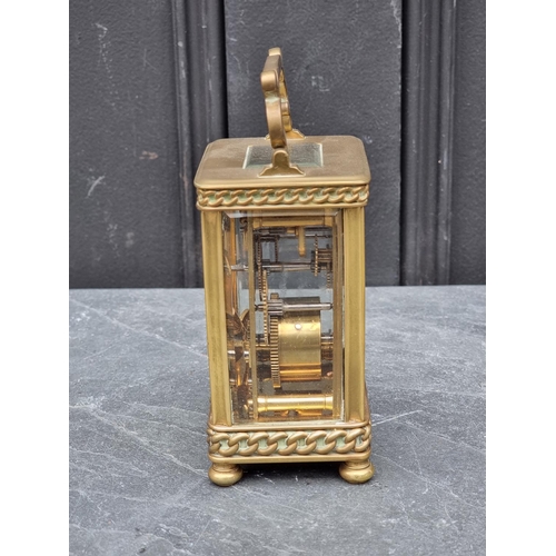 1448 - An old brass carriage timepiece, height including handle 15cm. 