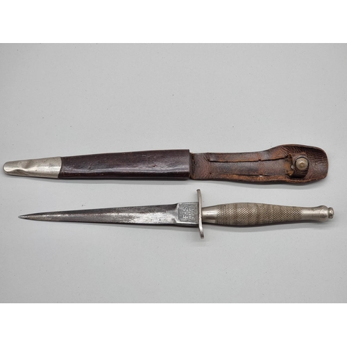 1500 - A rare circa 1940 Fairbairn-Sykes first pattern commando fighting knife and leather sheath, by Wilki... 