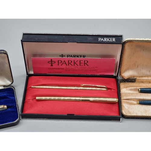 1502 - A group of vintage pens, comprising: a cased Parker silver pen set, circa 1964, (s.d. to one); a Par... 