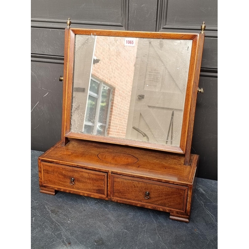 1065 - A George III mahogany and line inlaid toilet mirror, 48cm wide.