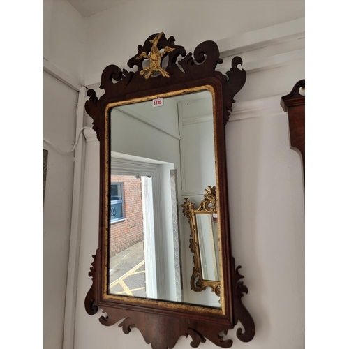 1125 - An 18th century walnut and parcel gilt fret frame wall mirror, 87.5 x 49.5cm.