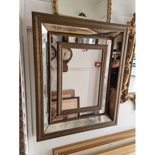 1126 - A brass framed wall mirror, 76.5 x 63cm.