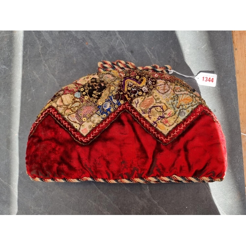 1344 - A Victorian embroidered tea cosy, 34cm wide.