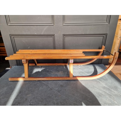 1357 - A beech and ply sled, 99cm long.