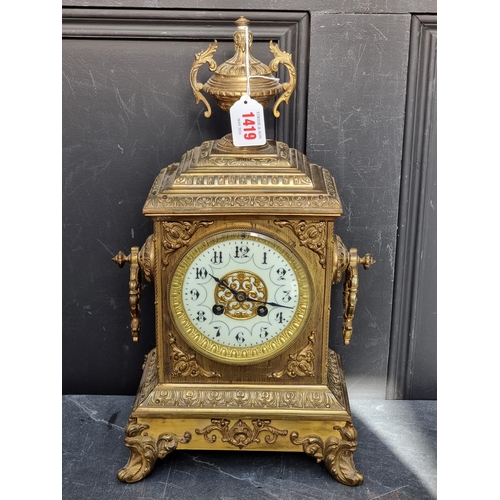 1419 - A circa 1900 century brass mantel clock, 40cm high, with pendulum.