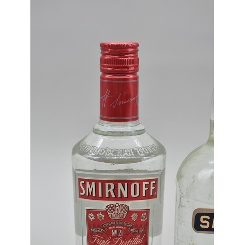 29 - A 1 litre bottle of Smirnoff Vodka, 50% abv, probably 1980s bottling; together with another later 70... 