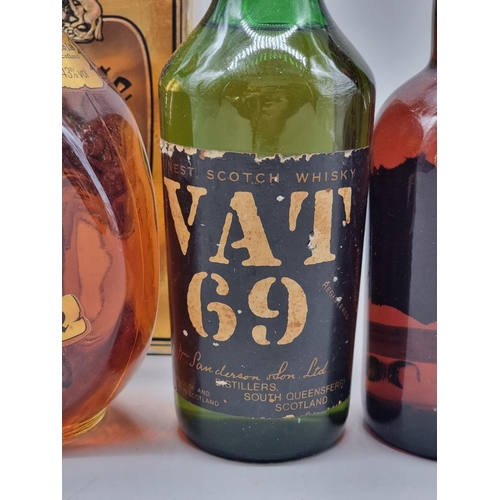 36 - Three old bottles of blended Whisky, comprising: an old 26 2/3 fl.oz. bottle of VAT 69; a 26 2/3 fl.... 