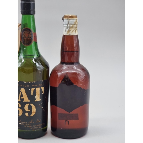 36 - Three old bottles of blended Whisky, comprising: an old 26 2/3 fl.oz. bottle of VAT 69; a 26 2/3 fl.... 