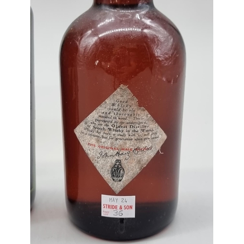 36 - Three old bottles of blended Whisky, comprising: an old 26 2/3 fl.oz. bottle of VAT 69; a 26 2/3 fl.... 