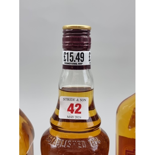 42 - Three bottles of blended Whisky, comprising: a 1 litre Grant's; a 1 litre Teacher's; and a 70cl Bell... 