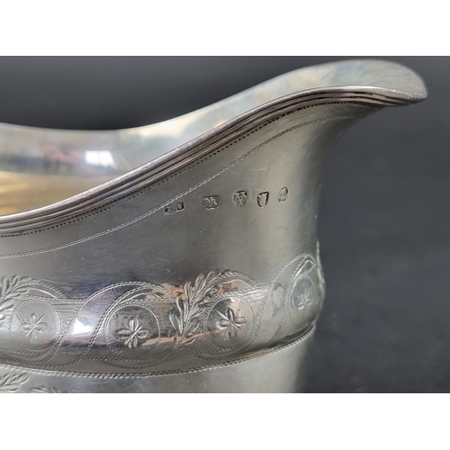 216 - A George III silver milk jug, probably by Thomas Wheatley, Newcastle, height to handle 11cm, 116g.... 