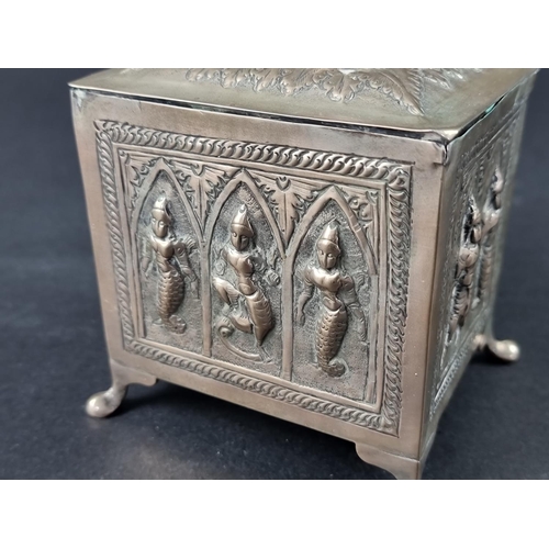 229 - An Eastern metal lidded box, the lid decorated Ganesh, 12cm high.