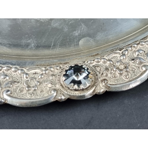 237 - A white metal tray, having faceted glass jewels to rim, stamped 'silver', 35cm diameter.... 