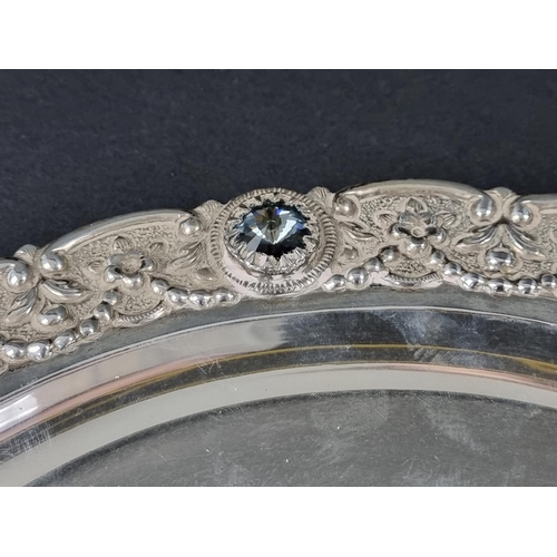 237 - A white metal tray, having faceted glass jewels to rim, stamped 'silver', 35cm diameter.... 