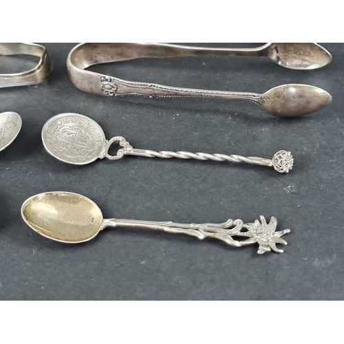 287 - Four pairs of silver tongs; together with a silver mounted pepperette; and seven silver and white me... 