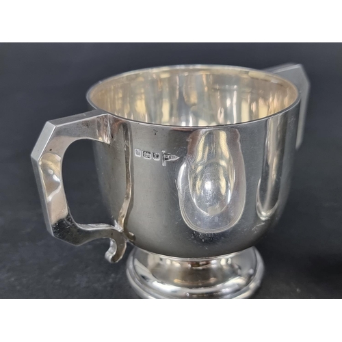 293 - An Edwardian silver twin handled cup, by Walker & Hall, Sheffield 1909, 8cm high; together with ... 