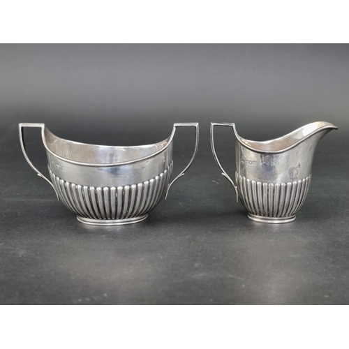 298 - A silver cream jug and matching sugar bowl, by William Hutton & Sons Ltd, London 1904, height to... 