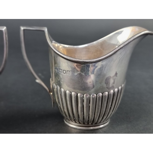 298 - A silver cream jug and matching sugar bowl, by William Hutton & Sons Ltd, London 1904, height to... 