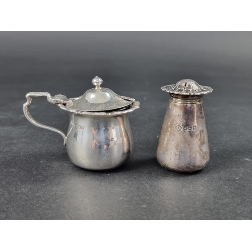 323 - A silver mustard pot, by James Ramsay, Sheffield 1911, 6.5cm high; together with a silver pepper, 79... 