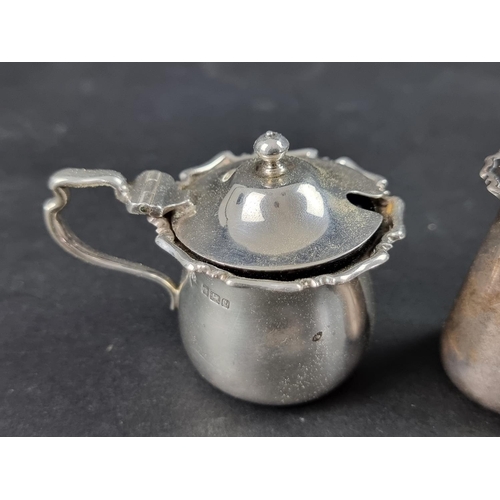 323 - A silver mustard pot, by James Ramsay, Sheffield 1911, 6.5cm high; together with a silver pepper, 79... 