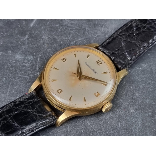 658 - A early 1960s IWC 18ct gold manual wind wristwatch, 33mm, on vintage Omega black leather strap.... 