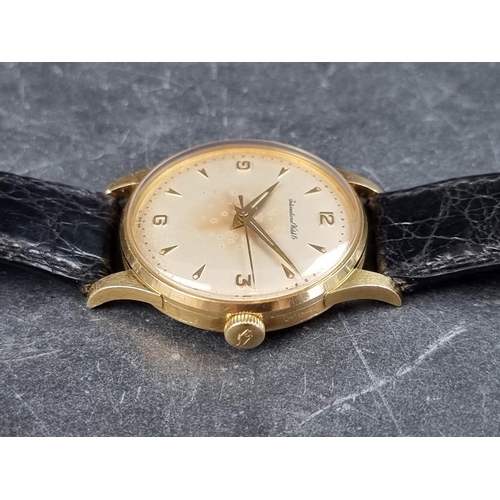 658 - A early 1960s IWC 18ct gold manual wind wristwatch, 33mm, on vintage Omega black leather strap.... 