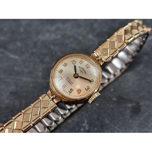 707 - A Rotary 9ct gold manual wind ladies wristwatch, 18mm, on gold plated expanding bracelet.... 