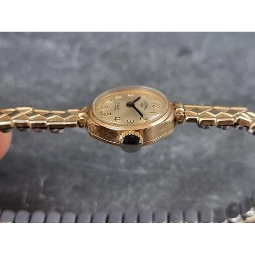 707 - A Rotary 9ct gold manual wind ladies wristwatch, 18mm, on gold plated expanding bracelet.... 