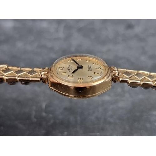 707 - A Rotary 9ct gold manual wind ladies wristwatch, 18mm, on gold plated expanding bracelet.... 