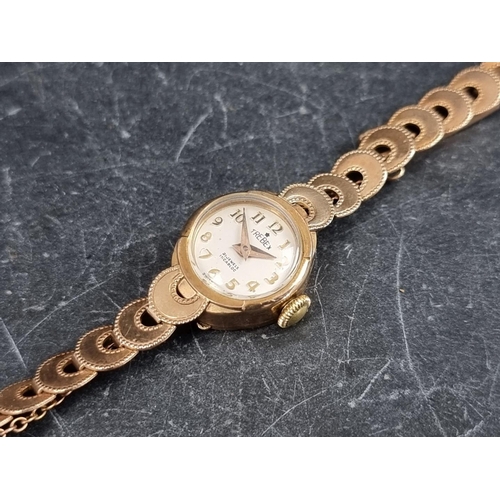 709 - A Trebex 9ct gold manual wind ladies wristwatch, 15mm, on 9ct gold bracelet.