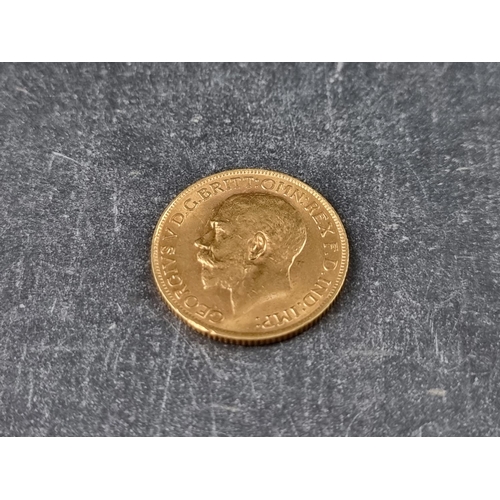 744 - Coins: a George V 1913 gold sovereign.