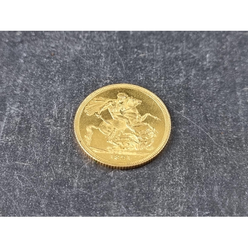 752 - Coins: a rare George IIII 1821 gold sovereign, in near uncirculated condition.