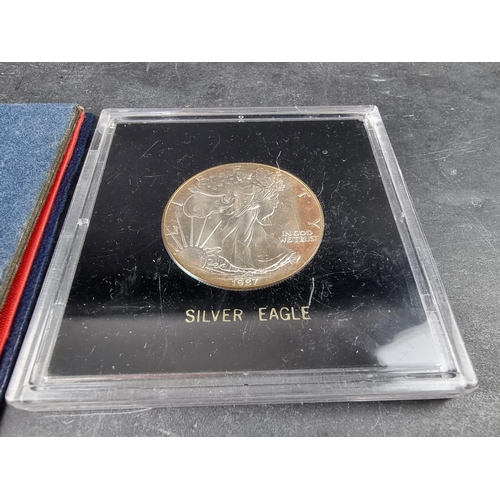 783 - Coins: a US Bicentennial silver proof coin set; together with a silver Eagle dollar, 1987; two San F... 