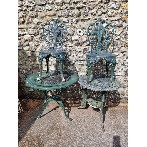 1632 - Two green painted aluminium garden tables, largest 80.5cm diameter; and a pair of similar chair... 