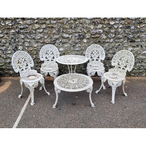 1634 - A set of four cast iron garden chairs and two tables.