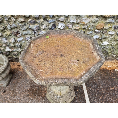 1650 - A large composition stone octagonal pedestal bird bath, 57.5cm wide.