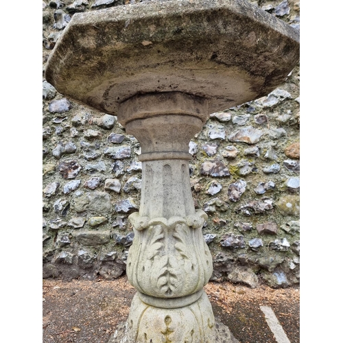 1650 - A large composition stone octagonal pedestal bird bath, 57.5cm wide.