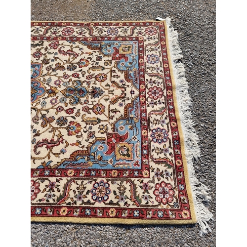 1656 - A Persian rug, having central flower medallion, with floral cartouches to each corner, with floral b... 