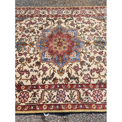 1656 - A Persian rug, having central flower medallion, with floral cartouches to each corner, with floral b... 